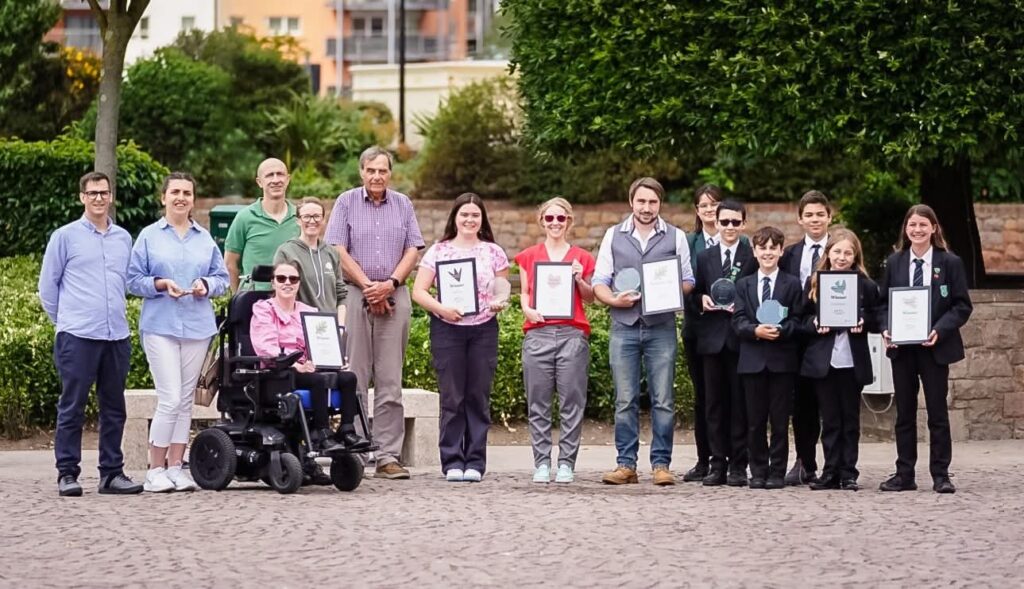Group holding awards outdoors