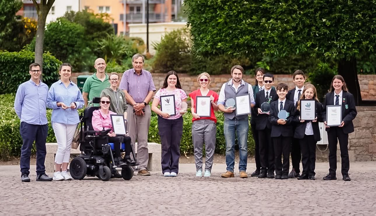 Group holding awards outdoors