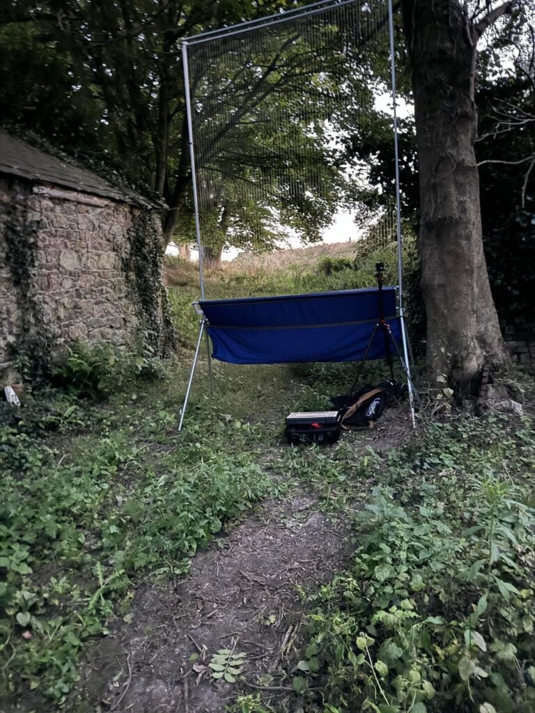 DIY golf practice net in garden setting.