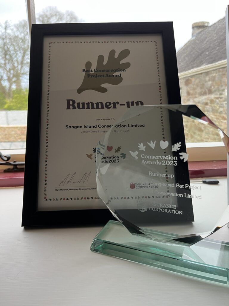Conservation award certificate and trophy on display.