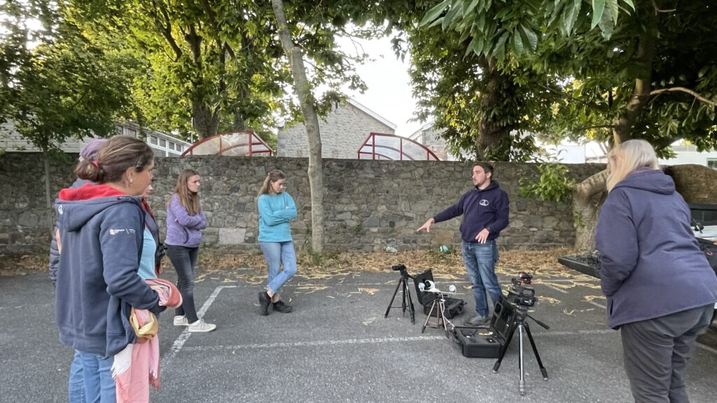 Outdoor group photography lesson with cameras and tripods.