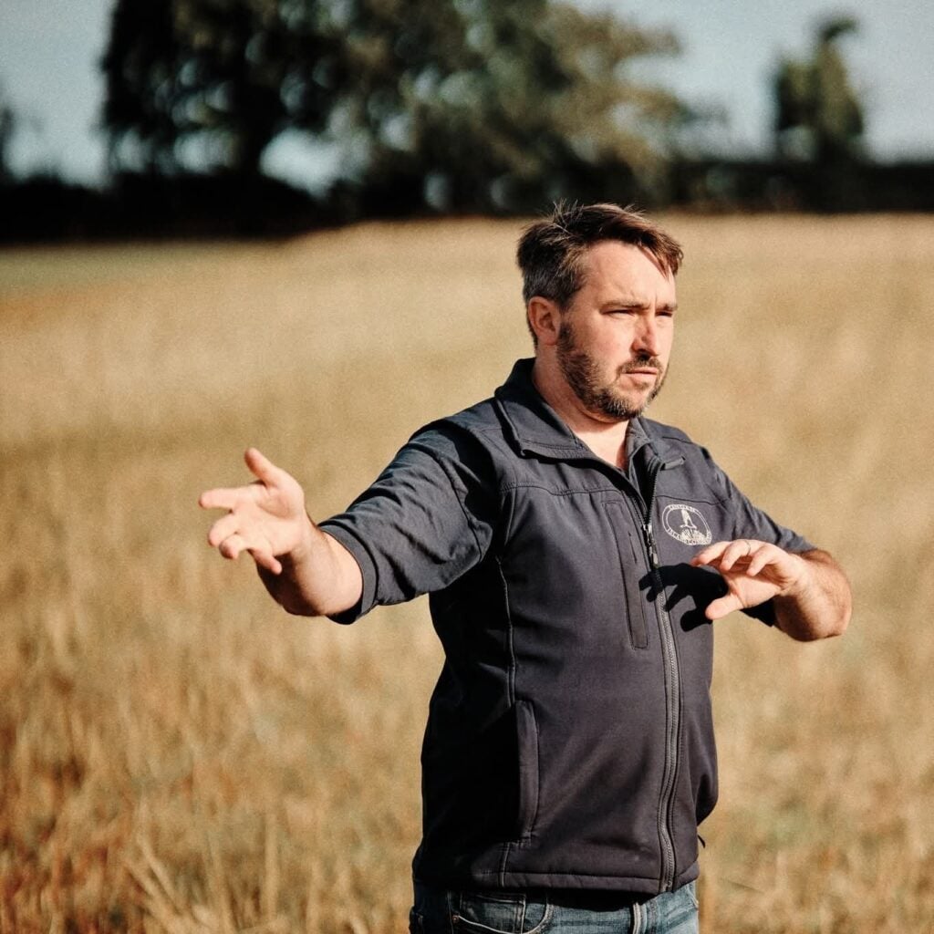 Man gesturing in sunny field